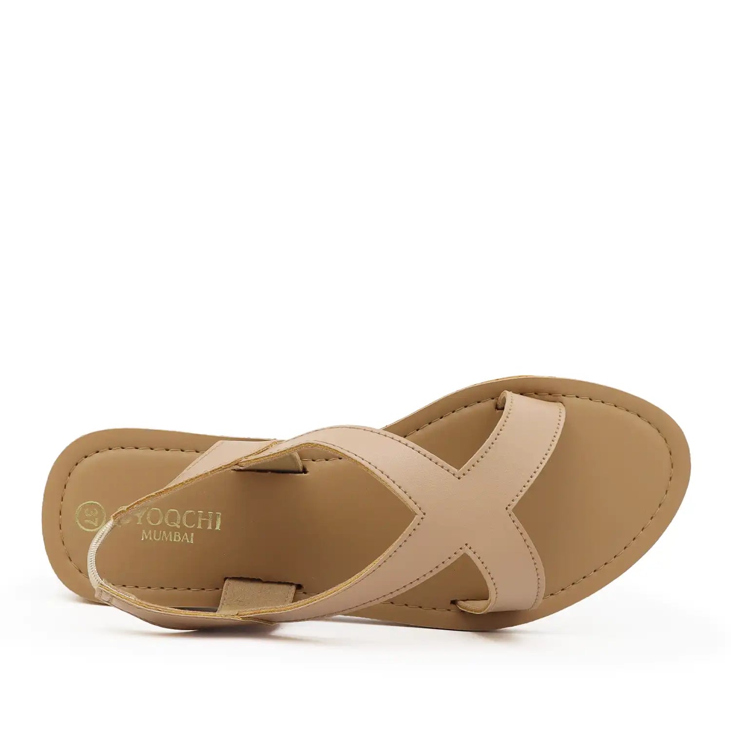 A pair of women's minimalist flat sandals with crisscrossing straps and a tan sole, top view