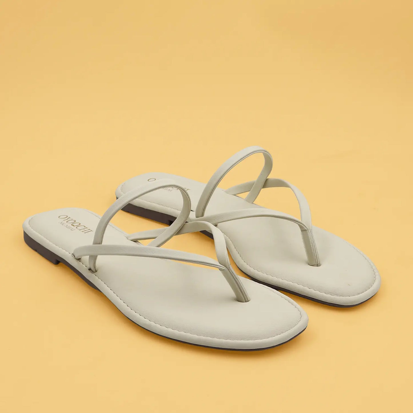 Oyoqchi women's beige flat sandals pair view