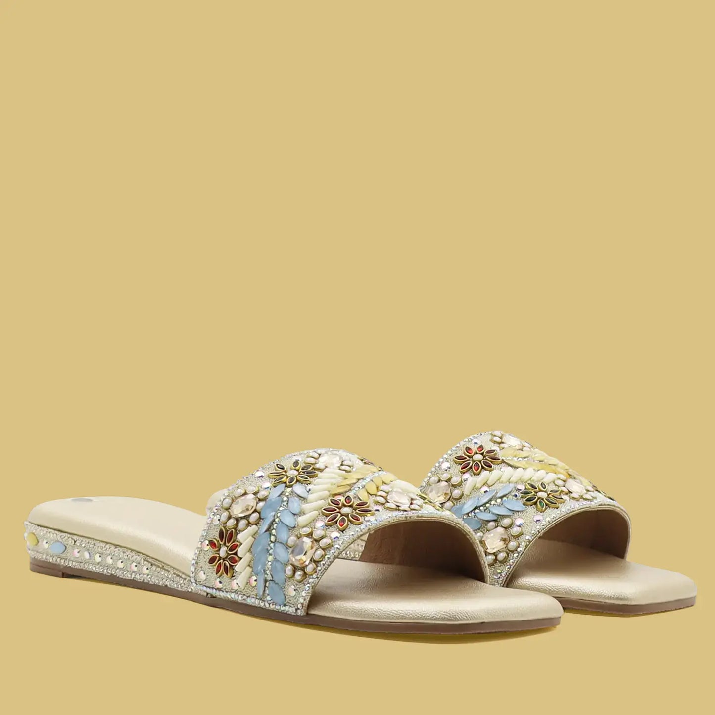 pair of women’s gold embellished ethnic flat sandals with beaded upper, front angle view