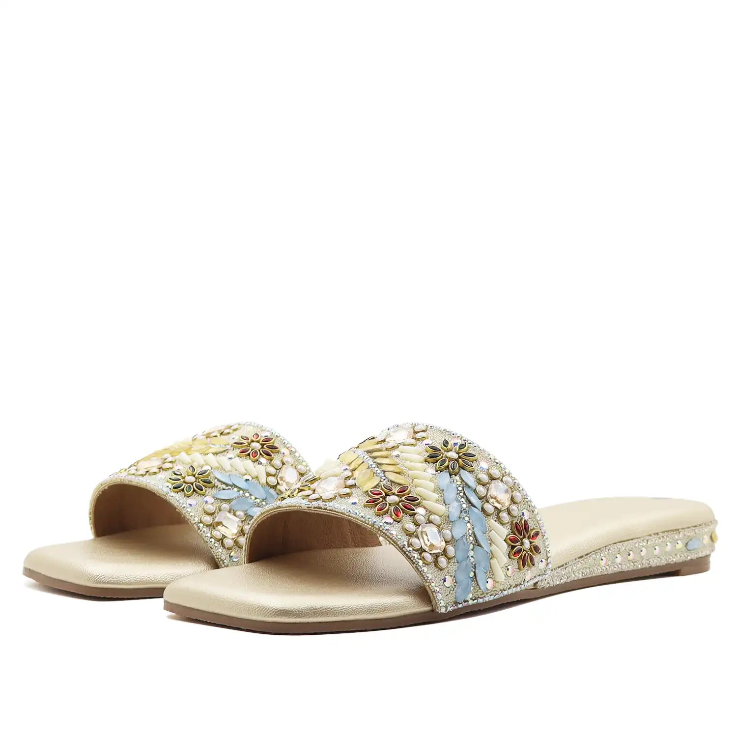 pair of women’s gold embellished ethnic flat sandals with beaded upper, angle view