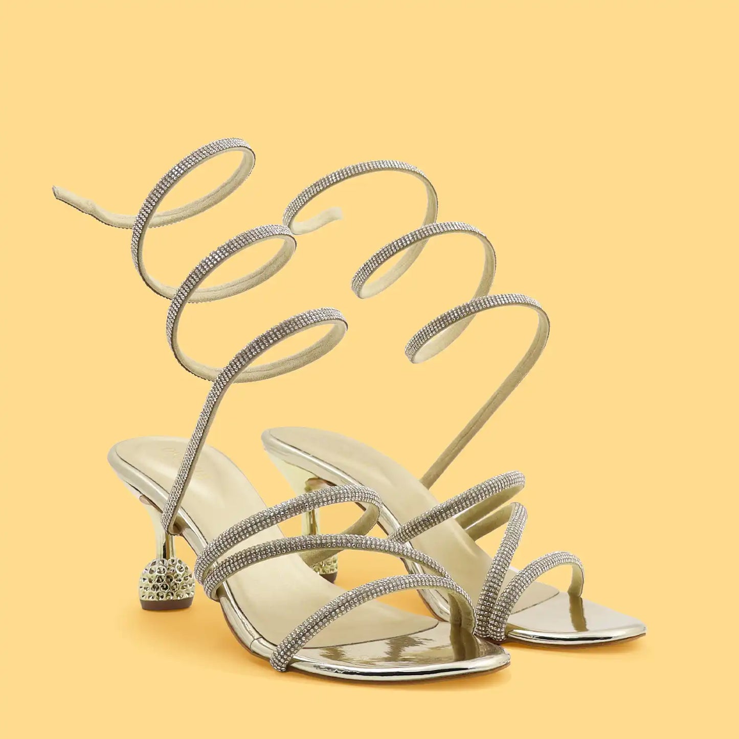 Oyoqchi women's partywear gold strappy heeled sandals on a yellow background
