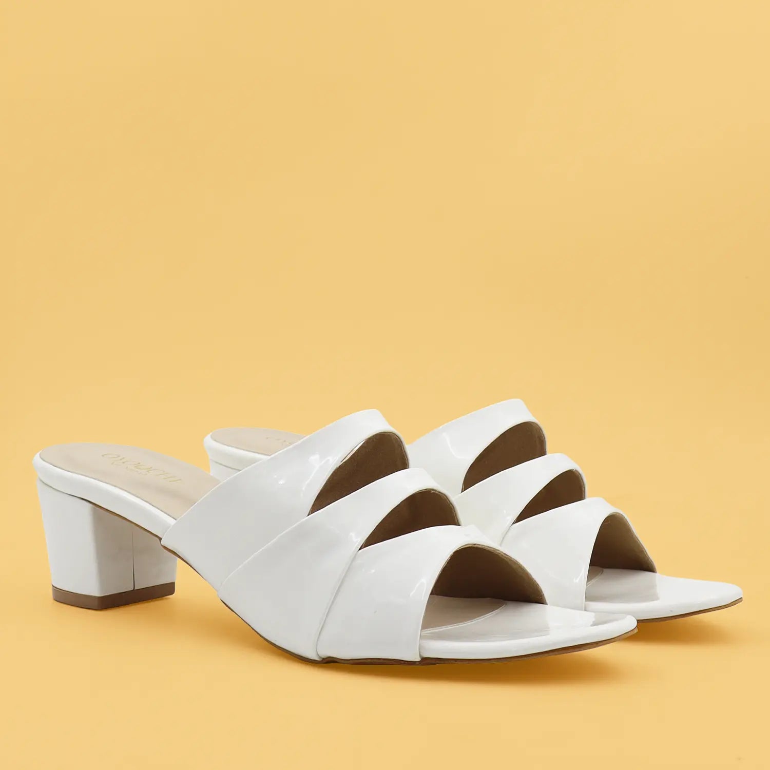 A pair of women's white block heel sandals