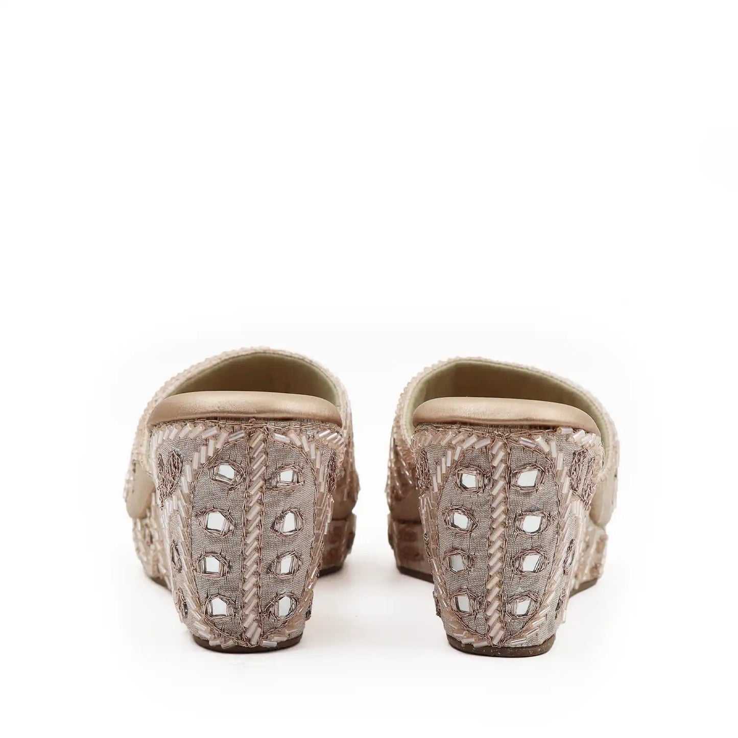 Heel view of women's ethnic rose gold wedge sandals