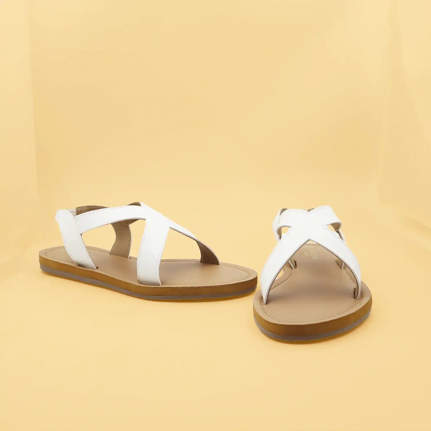 Women's white criss-cross flat sandals with a brown  sole and sling back Design