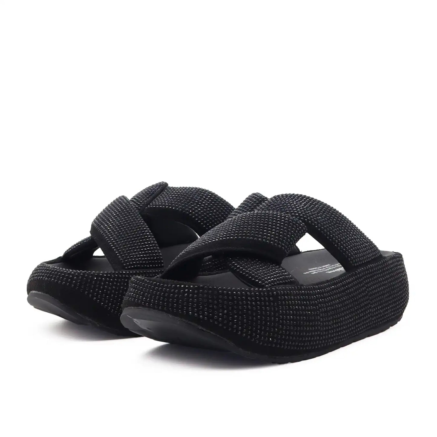 A pair of black women platform slide sandals with wide, textured woven straps, shown on a plain white background.