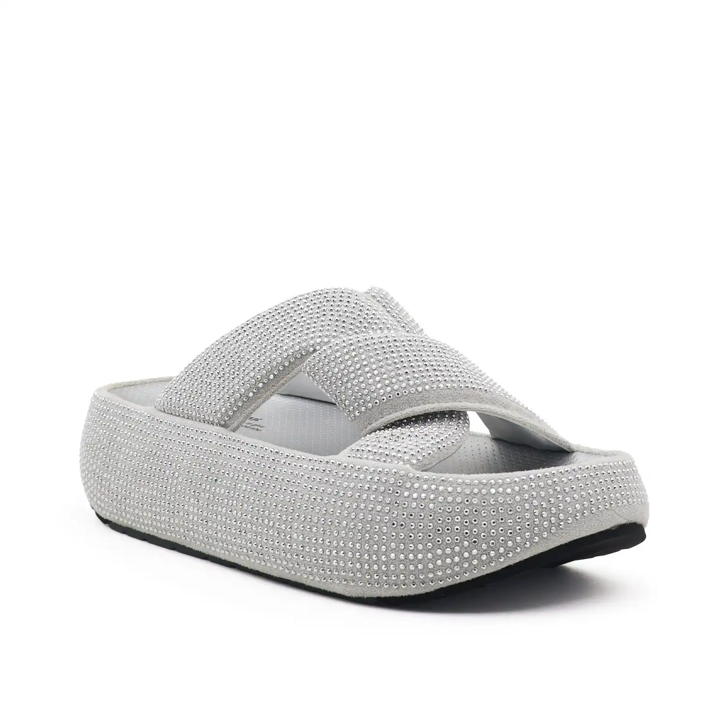A single platform slide sandal covered in silver rhinestones, featuring a wide crossover strap and a thick cushioned sole