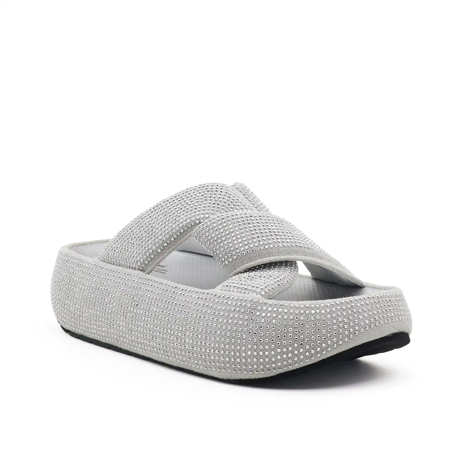 A single platform slide sandal covered in silver rhinestones, featuring a wide crossover strap and a thick cushioned sole