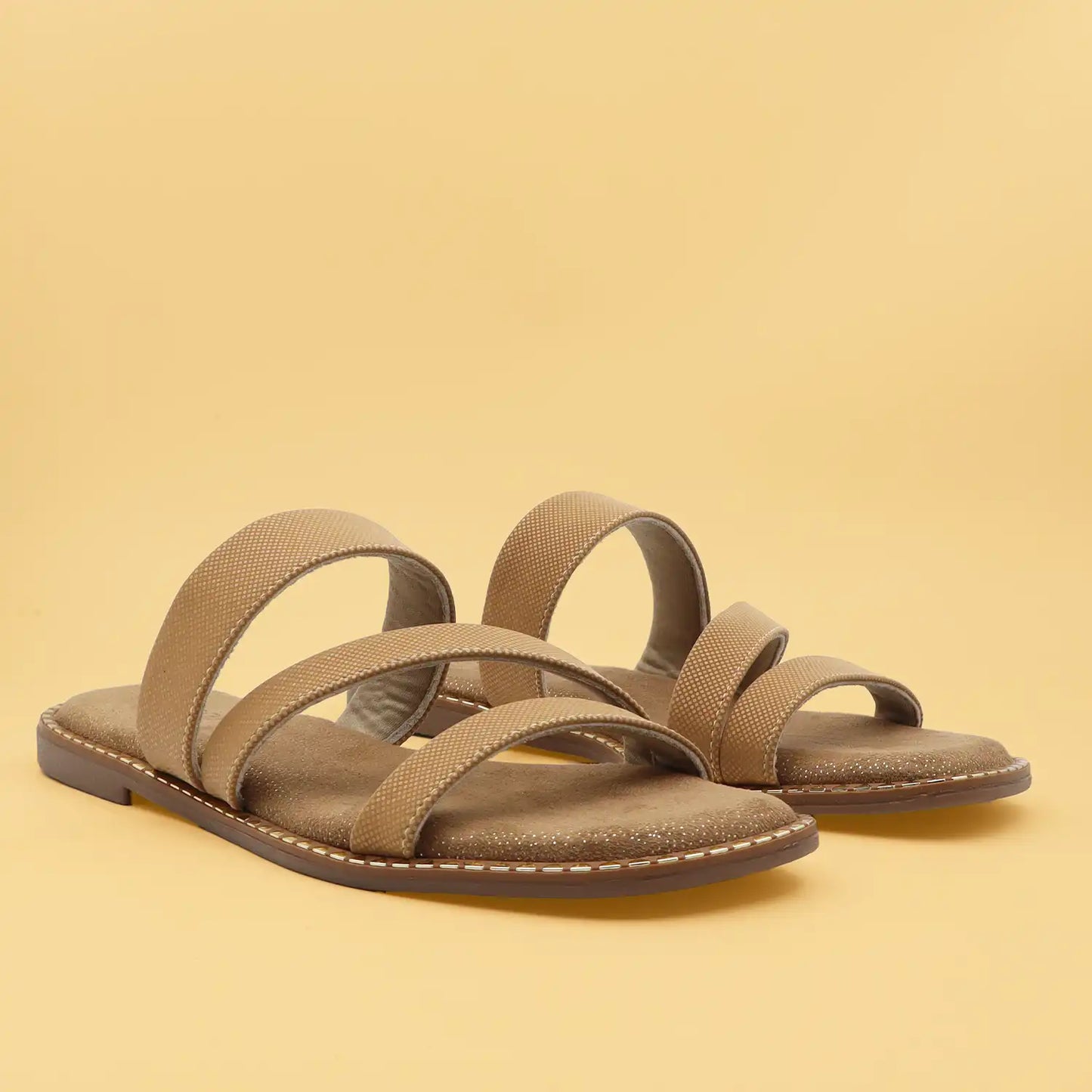 A pair of women's flat strappy sandals featuring a comfortable footbed and z shape straps