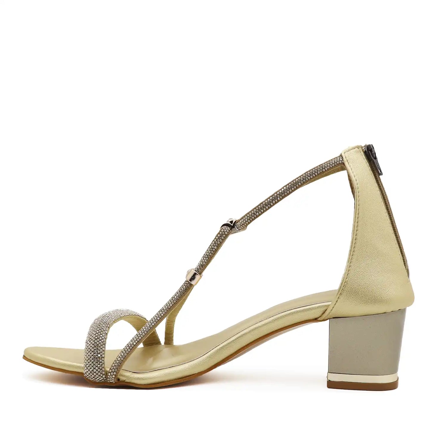 A single women's heeled sandal in a light champagne gold color, featuring a block heel, a thin ankle strap, and a toe strap embellished with sparkling gold rhinestones