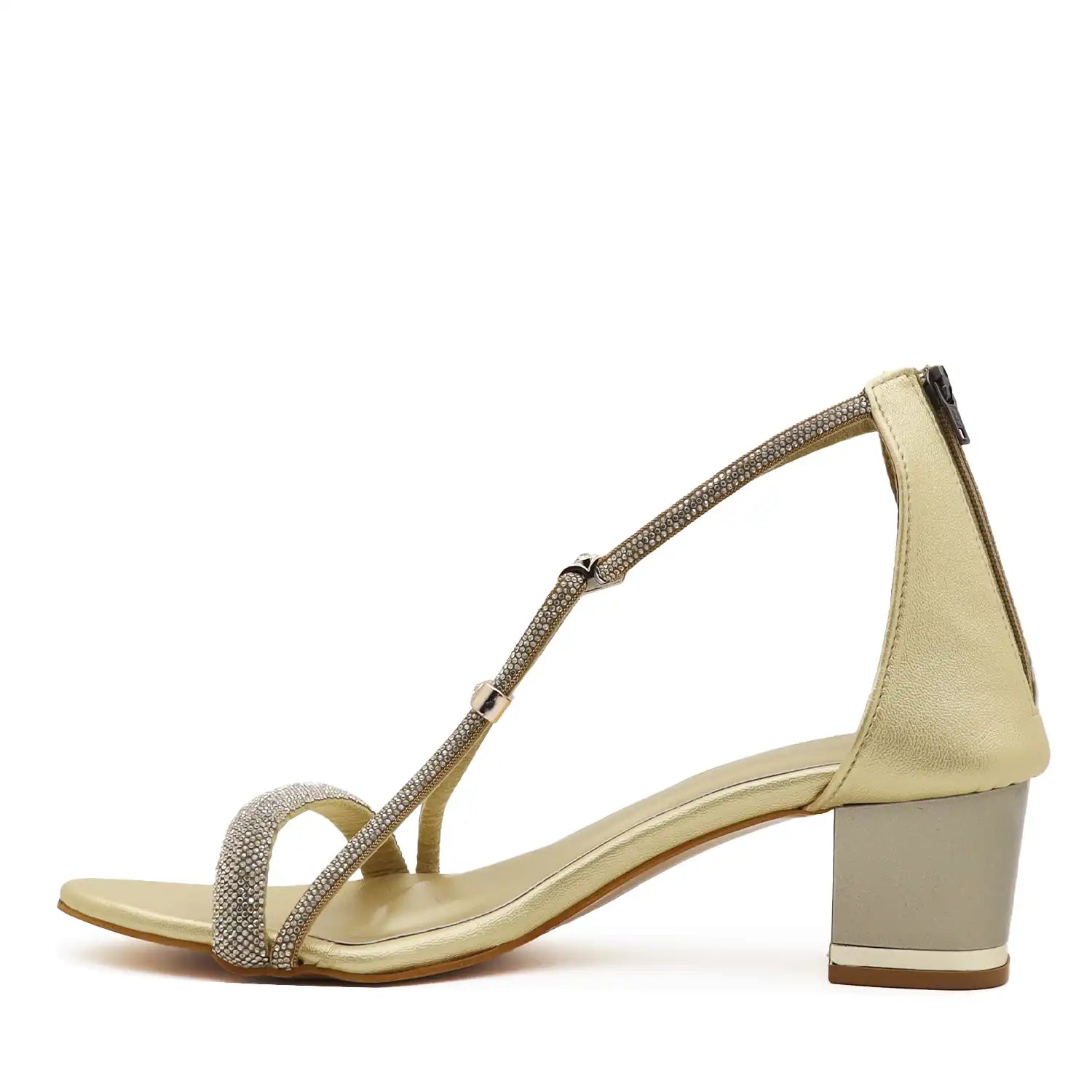 A single women's heeled sandal in a light champagne gold color, featuring a block heel, a thin ankle strap, and a toe strap embellished with sparkling gold rhinestones
