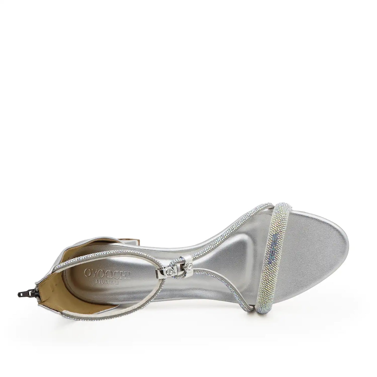 A single silver metallic heeled sandal  for women, shown from a side profile view on a white background. The sandal features a square toe, a low block heel, a zippered ankle strap
